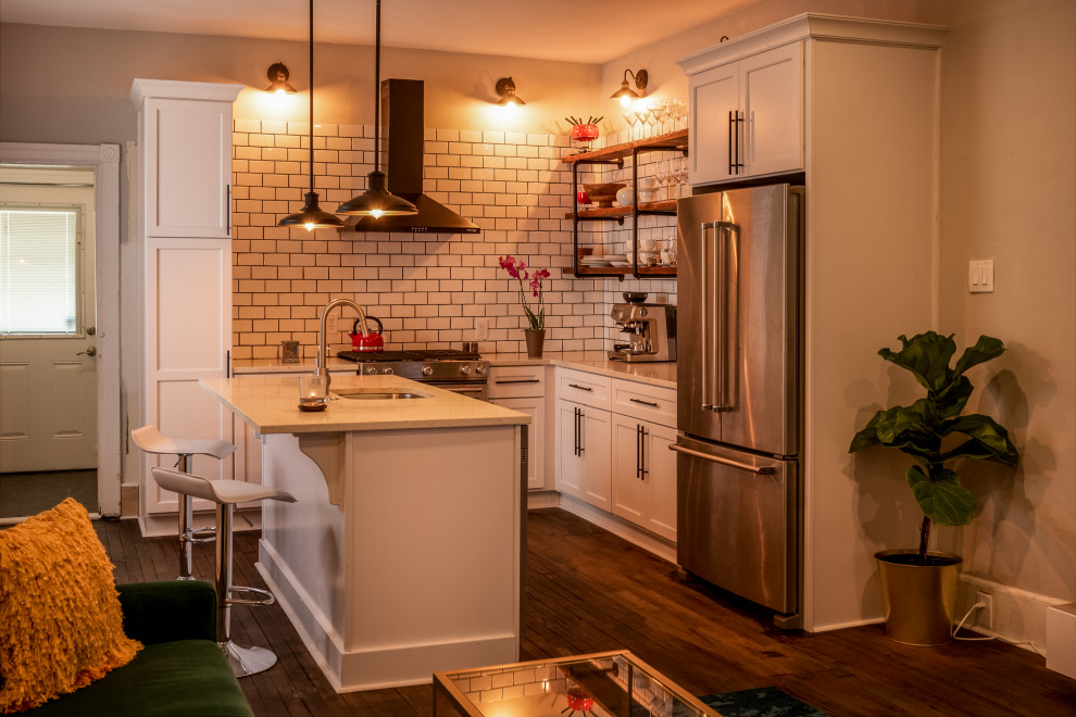 Inspiration for a small scandinavian l-shaped kitchen in Philadelphia with an undermount sink, shaker cabinets, white cabinets, quartz benchtops, white splashback, subway tile splashback, stainless steel appliances, medium hardwood floors and with island.