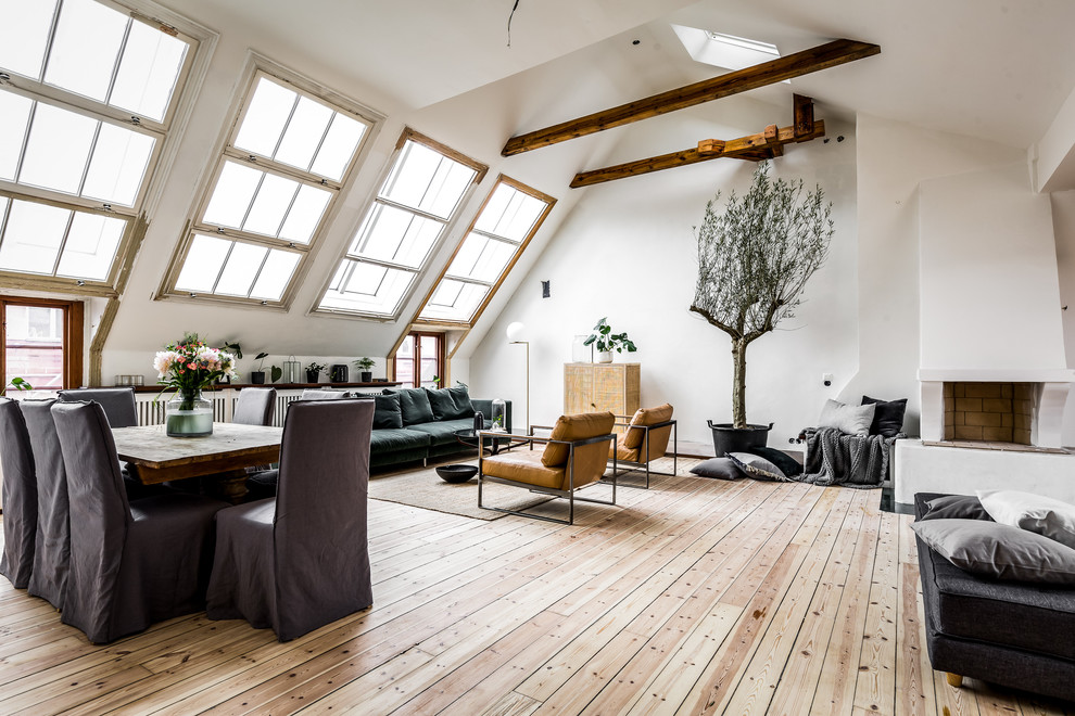 This is an example of a large scandinavian loft-style family room in Stockholm with white walls.