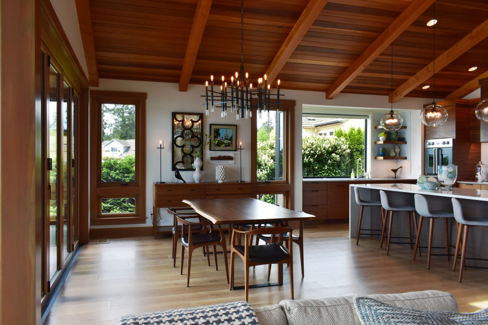 Photo of a contemporary open plan dining in Seattle with white walls, light hardwood floors, beige floor, exposed beam, vaulted and wood.