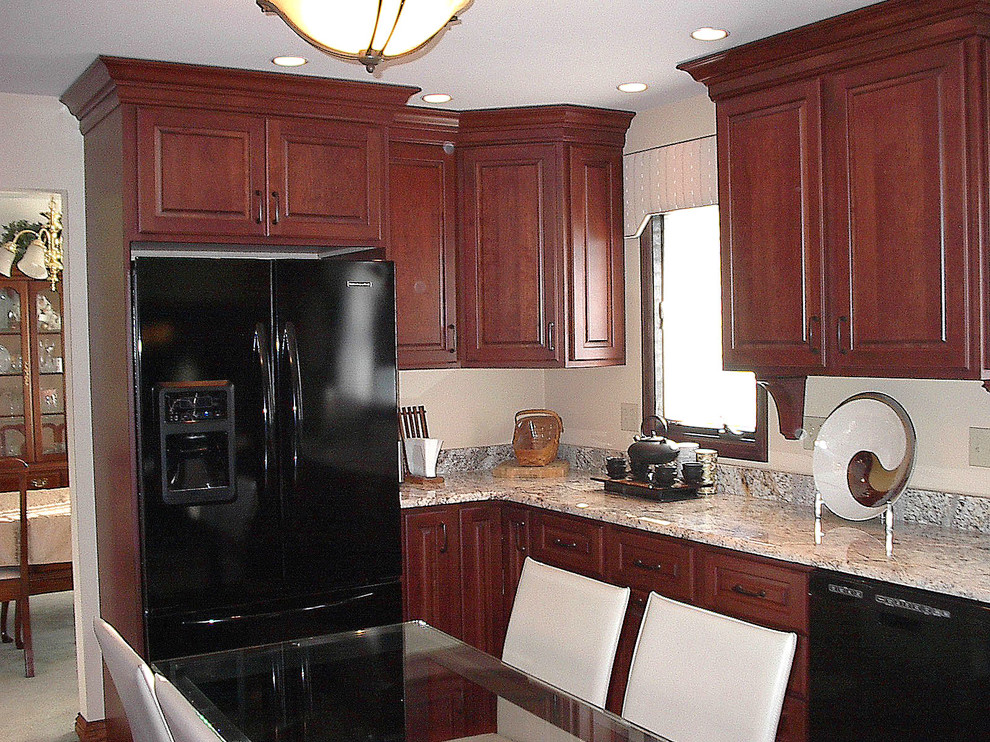 Enclosed kitchen - small transitional u-shaped dark wood floor enclosed kitchen idea with raised-panel cabinets, dark wood cabinets, granite countertops, black appliances, an undermount sink and a peninsula