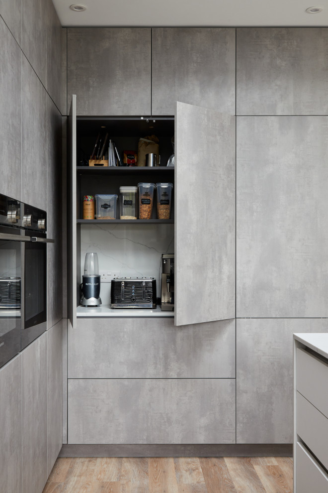 Design ideas for a mid-sized modern u-shaped kitchen in London with flat-panel cabinets, grey cabinets and with island.