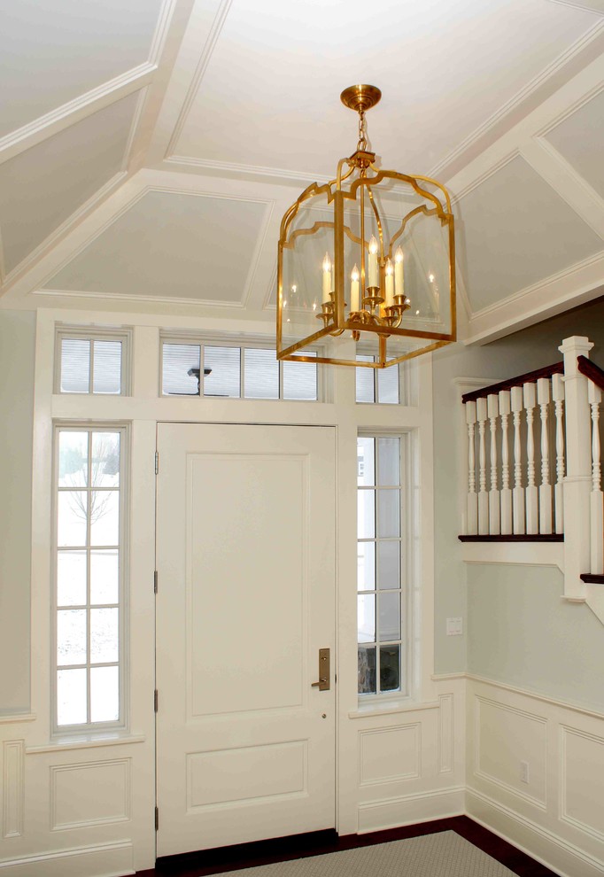 Inspiration for a large transitional dark wood floor front door remodel with blue walls and a white front door