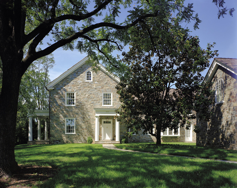 This is an example of a traditional two-storey exterior in DC Metro with stone veneer and a gable roof.