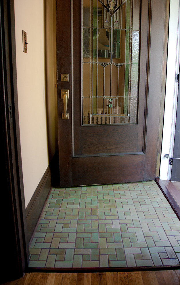 Small arts and crafts front door in Minneapolis with ceramic floors, a dark wood front door, beige walls and a single front door.