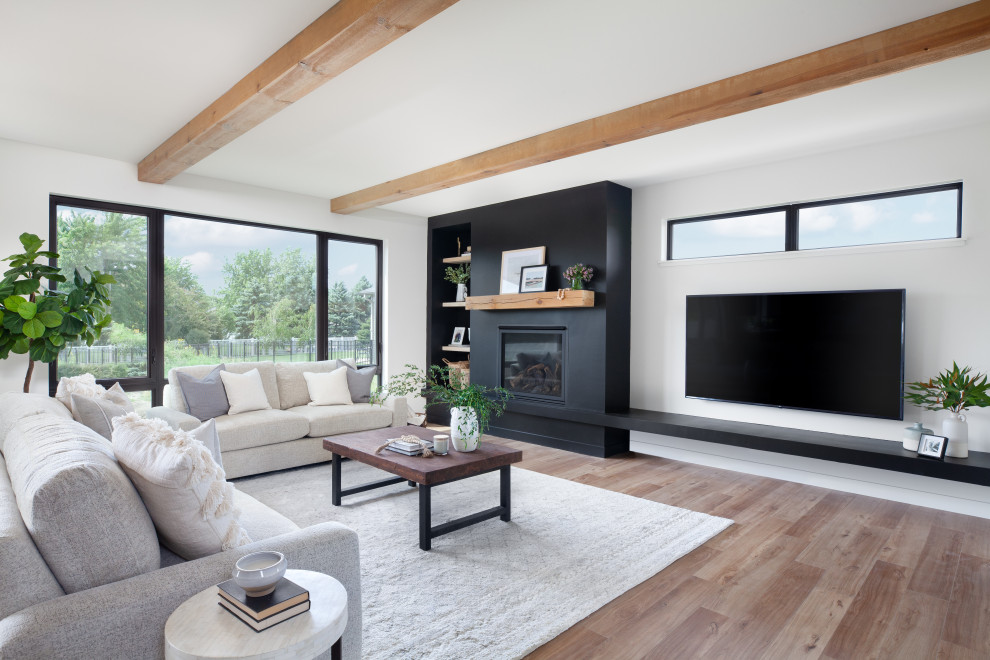 Design ideas for a scandinavian living room in Other with black walls, light hardwood flooring, a standard fireplace and exposed beams.