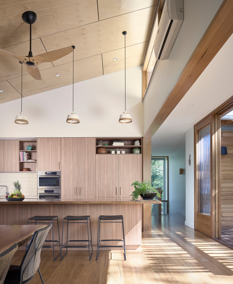 Design ideas for a mid-sized contemporary l-shaped open plan kitchen in Brisbane with a double-bowl sink, open cabinets, medium wood cabinets, concrete benchtops, white splashback, ceramic splashback, stainless steel appliances, light hardwood floors, with island, grey benchtop and timber.