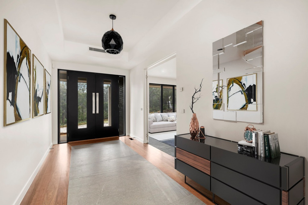 This is an example of a modern foyer in Melbourne with dark hardwood floors, a double front door, a black front door, brown floor, recessed and white walls.