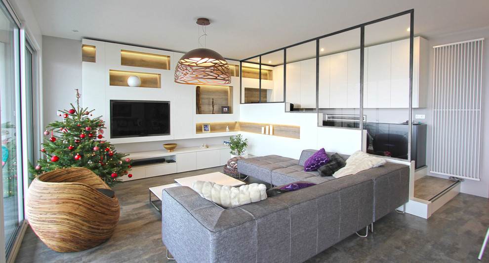This is an example of a mid-sized contemporary open concept living room in Lyon with no fireplace, a library, white walls, laminate floors, a built-in media wall and grey floor.