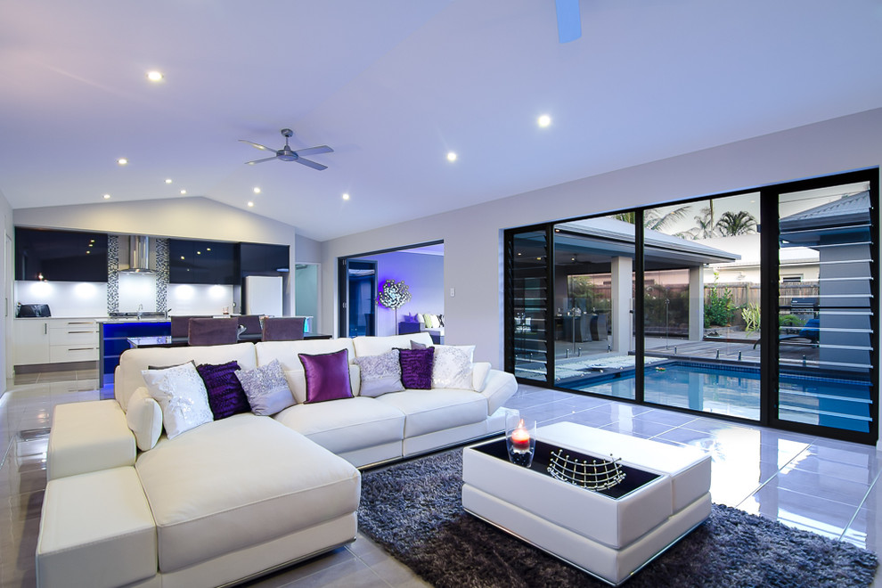 This is an example of a mid-sized contemporary open concept living room in Cairns with white walls and ceramic floors.