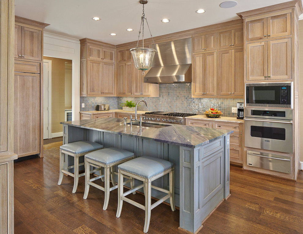 Inspiration for a large traditional l-shaped eat-in kitchen in Dallas with an undermount sink, beaded inset cabinets, light wood cabinets, quartzite benchtops, blue splashback, ceramic splashback, stainless steel appliances, dark hardwood floors, with island, brown floor and multi-coloured benchtop.