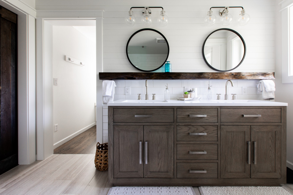This is an example of a mid-sized transitional master bathroom in Other with shaker cabinets, grey cabinets, a freestanding tub, an open shower, a two-piece toilet, white tile, ceramic tile, grey walls, ceramic floors, an undermount sink, engineered quartz benchtops, brown floor, an open shower, white benchtops, an enclosed toilet, a double vanity, a freestanding vanity and planked wall panelling.
