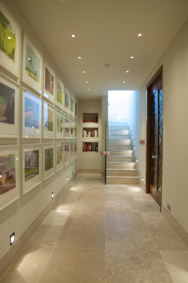 This is an example of a contemporary hallway in London with limestone floors.