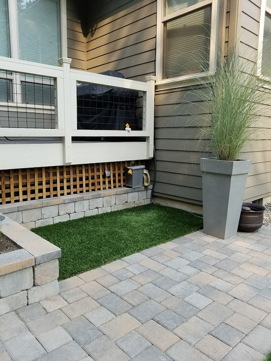 Mid-sized traditional backyard full sun xeriscape in Portland with brick pavers and a container garden for summer.