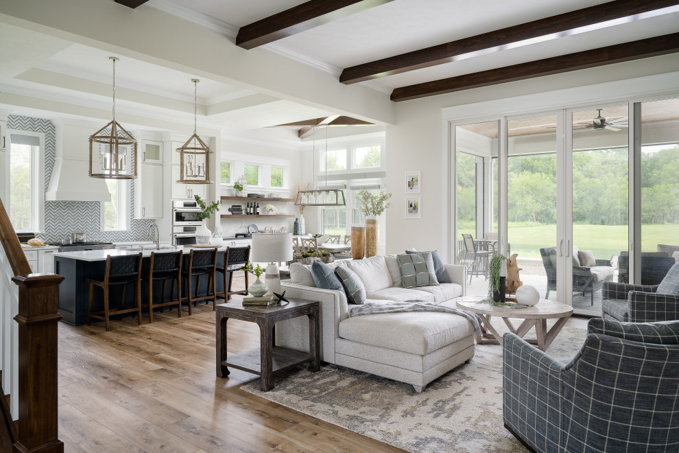 Example of a mid-sized farmhouse formal and enclosed medium tone wood floor living room design in Indianapolis with white walls, a standard fireplace, a metal fireplace and no tv