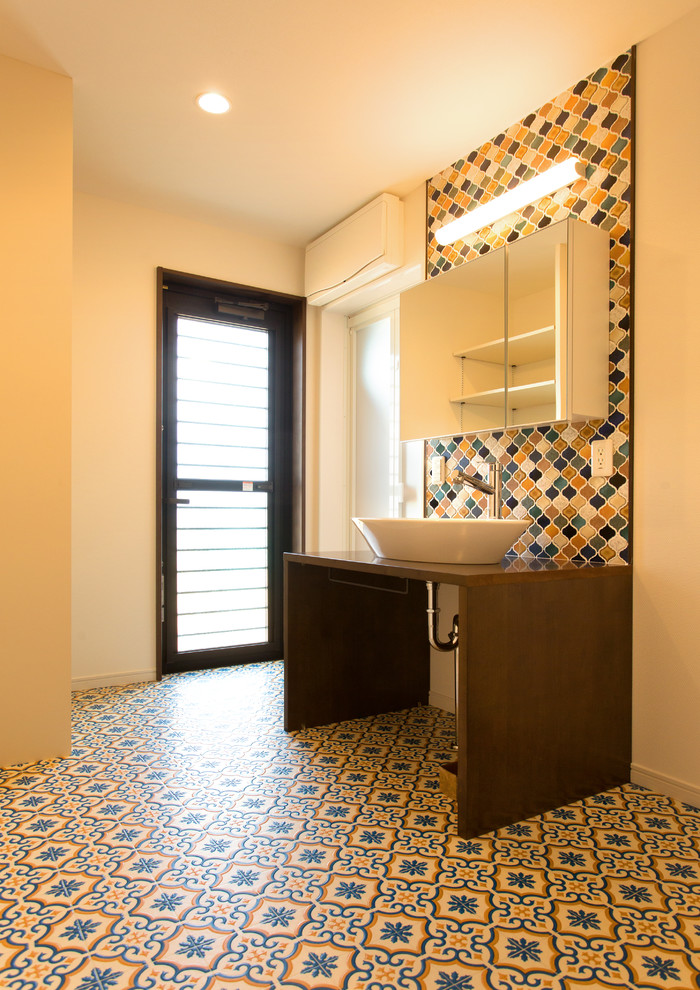 Photo of a midcentury powder room in Other with white walls, a vessel sink and multi-coloured floor.
