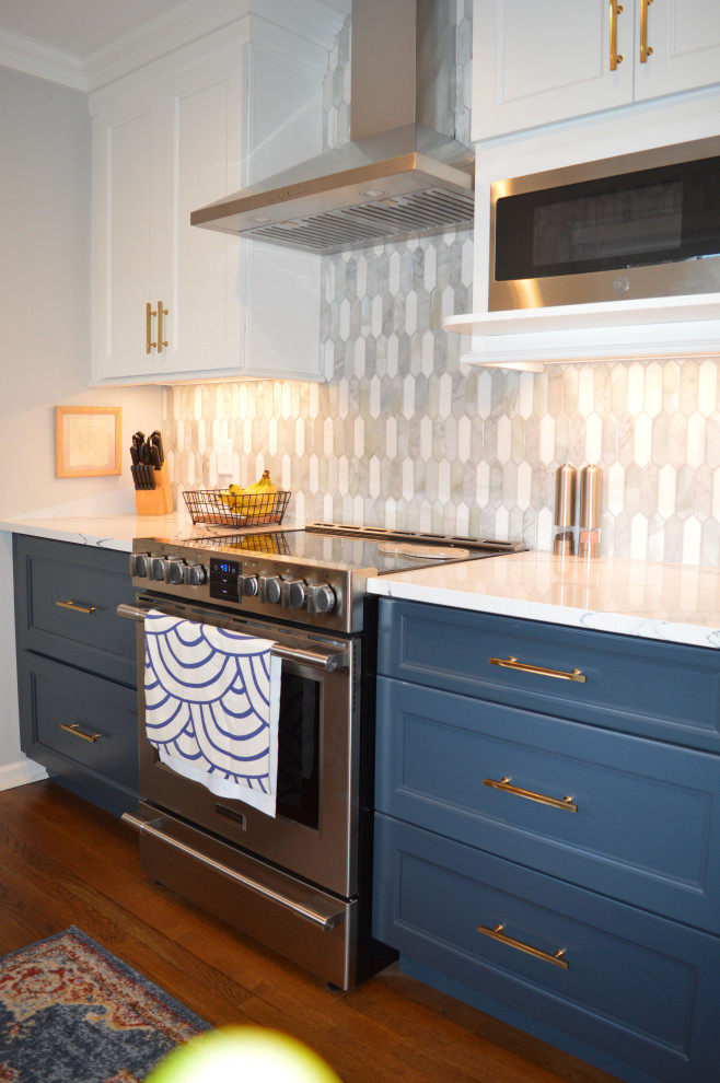 Inspiration for a transitional medium tone wood floor and brown floor kitchen remodel in New York with a drop-in sink, marble countertops, white backsplash, ceramic backsplash, stainless steel appliances and white countertops