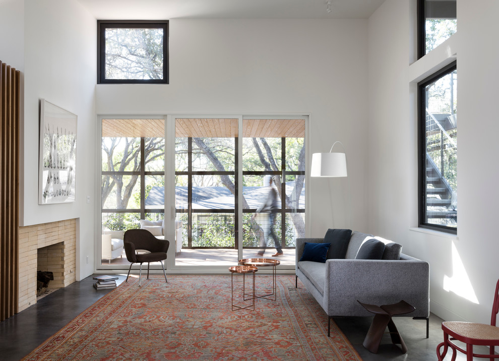 Inspiration for a midcentury living room in Austin with white walls.