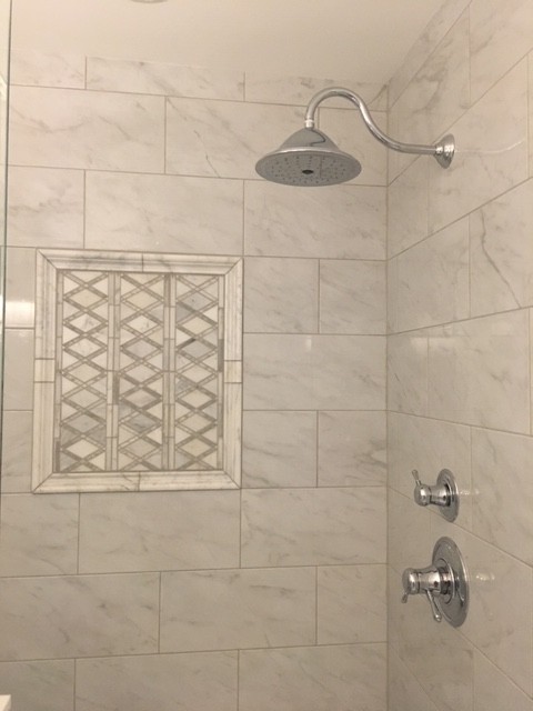 Medium sized classic ensuite bathroom in Charlotte with beaded cabinets, white cabinets, an alcove bath, an alcove shower, a two-piece toilet, white tiles, porcelain tiles, white walls, porcelain flooring, a submerged sink, marble worktops, a hinged door and white worktops.