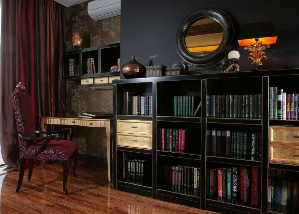 Photo of a transitional home office in Moscow with black walls, medium hardwood floors, a freestanding desk and brown floor.