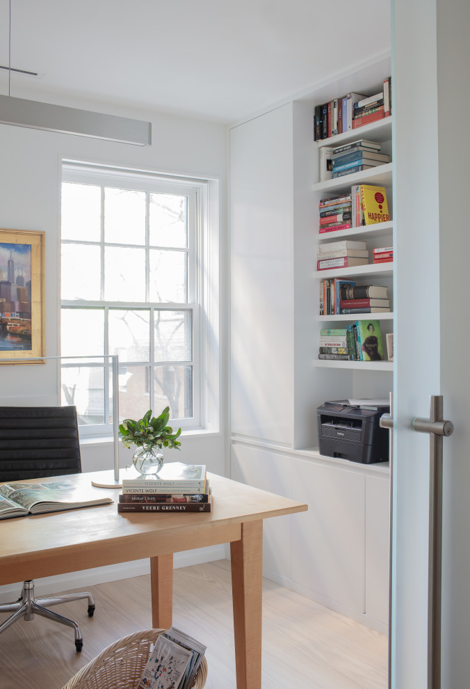 Esempio di un piccolo ufficio contemporaneo con pareti bianche, parquet chiaro e scrivania autoportante