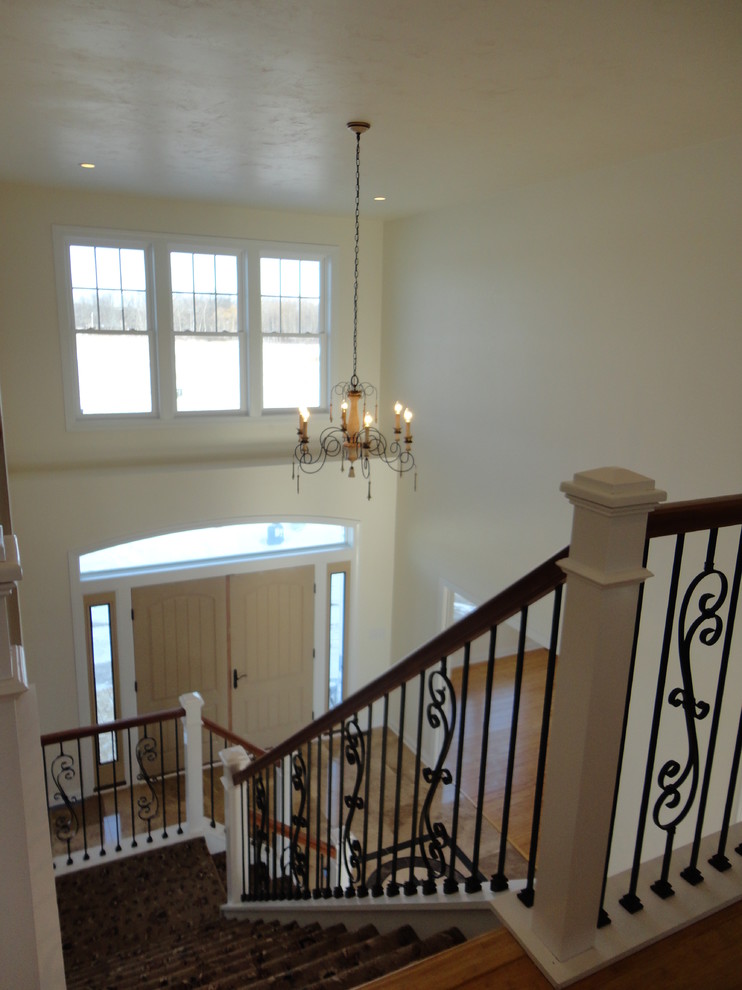 Mid-sized traditional foyer in Milwaukee with white walls, marble floors and a double front door.