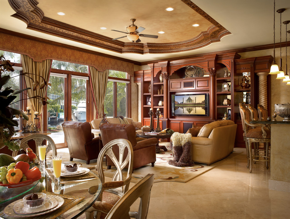 This is an example of a mid-sized mediterranean open concept family room in Miami with beige walls, a built-in media wall, a home bar, porcelain floors, beige floor and no fireplace.