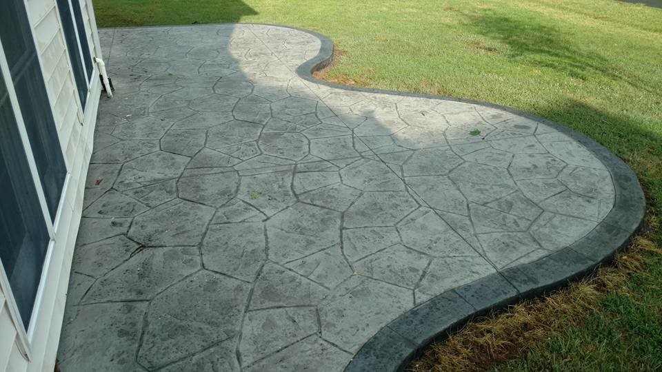 Large traditional backyard patio in Other with a fire feature, stamped concrete and no cover.