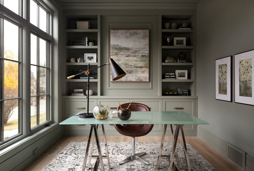 Photo of a transitional home office in Calgary with grey walls and light hardwood floors.