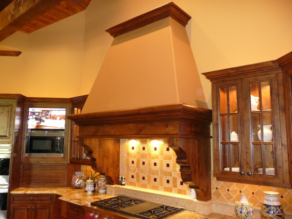 Inspiration for a huge rustic u-shaped medium tone wood floor kitchen remodel in Phoenix with raised-panel cabinets, medium tone wood cabinets, granite countertops, multicolored backsplash, stone tile backsplash, stainless steel appliances and an island