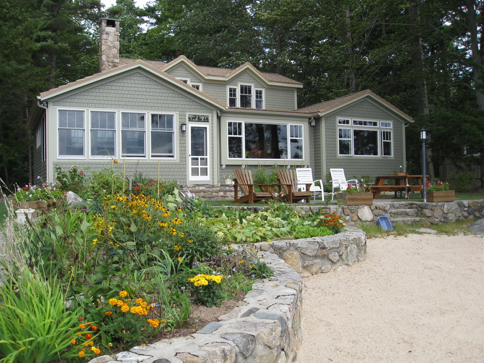 Design ideas for a mid-sized traditional two-storey exterior in Portland Maine with vinyl siding.
