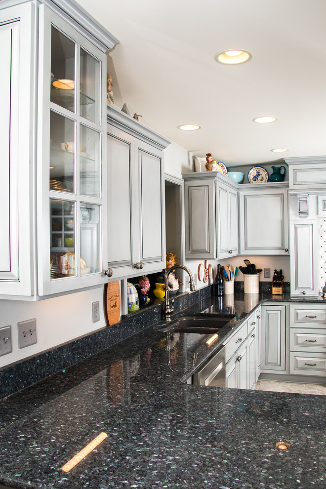 Example of a large transitional u-shaped porcelain tile and beige floor eat-in kitchen design in Milwaukee with an undermount sink, raised-panel cabinets, gray cabinets, granite countertops, white backsplash, marble backsplash, stainless steel appliances and no island