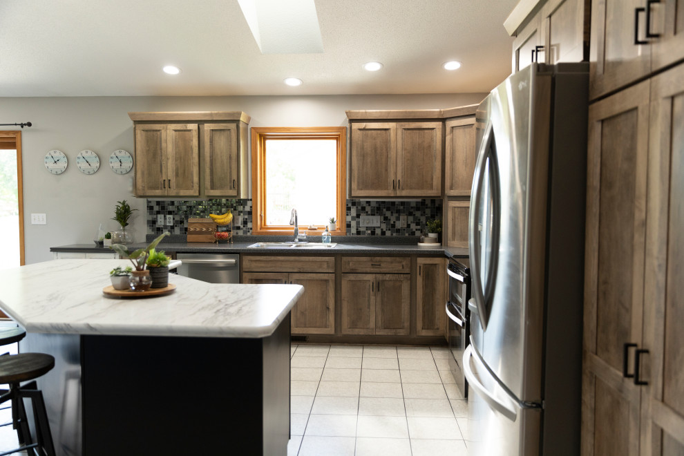 Example of a mid-sized transitional l-shaped eat-in kitchen design with shaker cabinets, laminate countertops and an island