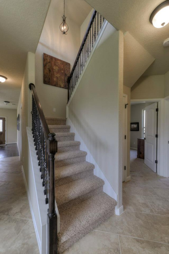 This is an example of a mid-sized transitional carpeted u-shaped staircase in Austin with carpet risers.