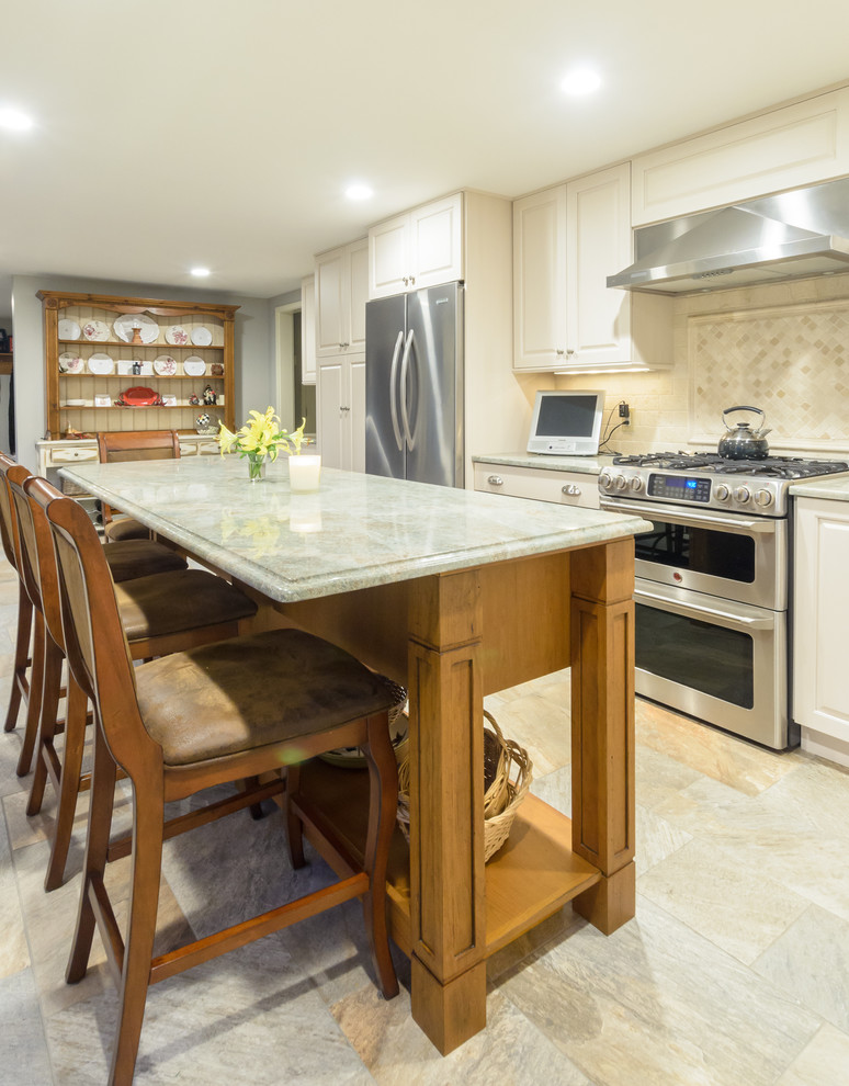 Inspiration for a traditional l-shaped eat-in kitchen in Boston with an undermount sink, raised-panel cabinets, beige cabinets, granite benchtops, ceramic splashback, stainless steel appliances and with island.
