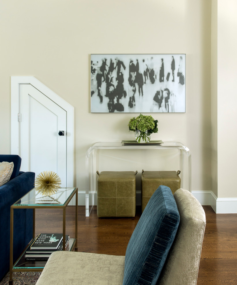 Example of a mid-sized transitional medium tone wood floor and brown floor foyer design in Boston with beige walls and a white front door