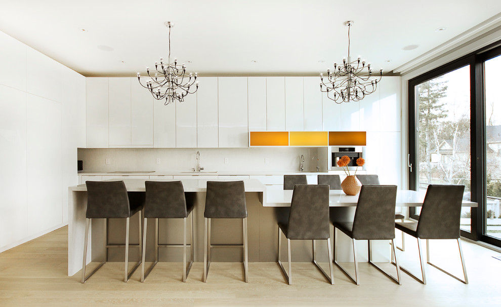 Inspiration for a large contemporary kitchen in Toronto with white cabinets, light hardwood floors, with island, a double-bowl sink, flat-panel cabinets, quartz benchtops, white splashback, stone slab splashback and panelled appliances.
