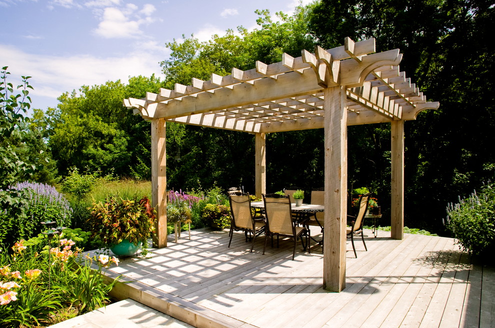 Design ideas for a traditional deck in Toronto with a pergola.