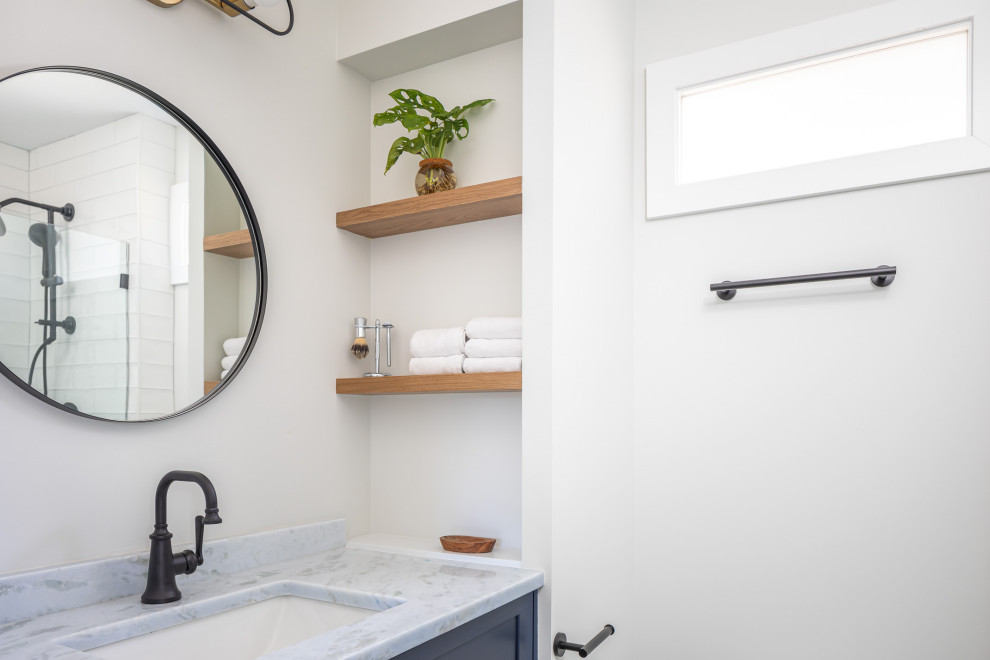 Photo of a small eclectic kids bathroom in Raleigh with shaker cabinets, grey cabinets, a bidet, white tile, porcelain tile, white walls, porcelain floors, an undermount sink, quartzite benchtops, blue floor, a sliding shower screen, white benchtops, a single vanity and a built-in vanity.