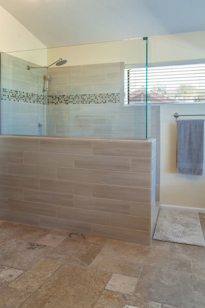 Large transitional master brown tile and porcelain tile ceramic tile walk-in shower photo in Phoenix with recessed-panel cabinets, dark wood cabinets, a two-piece toilet, beige walls, an undermount sink and granite countertops