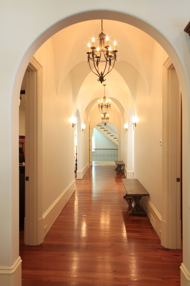 Photo of a large transitional hallway in Atlanta with white walls and medium hardwood floors.