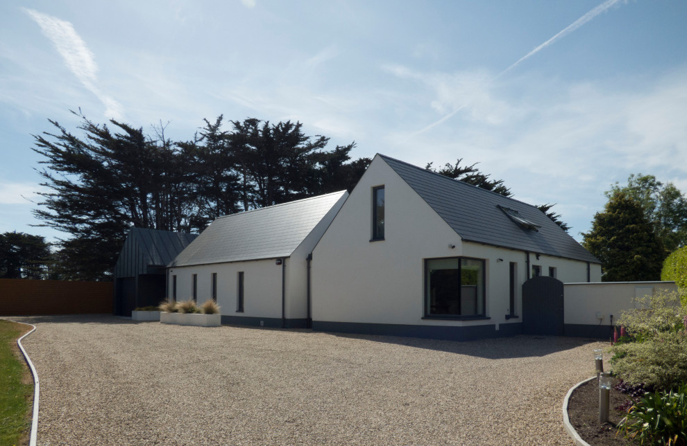 Design ideas for a medium sized and white two floor detached house in Dublin with metal cladding, a pitched roof, a metal roof and a grey roof.