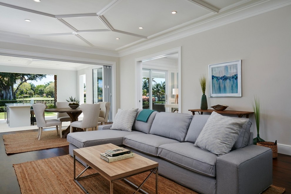 Design ideas for a transitional open concept living room in Miami with beige walls and dark hardwood floors.