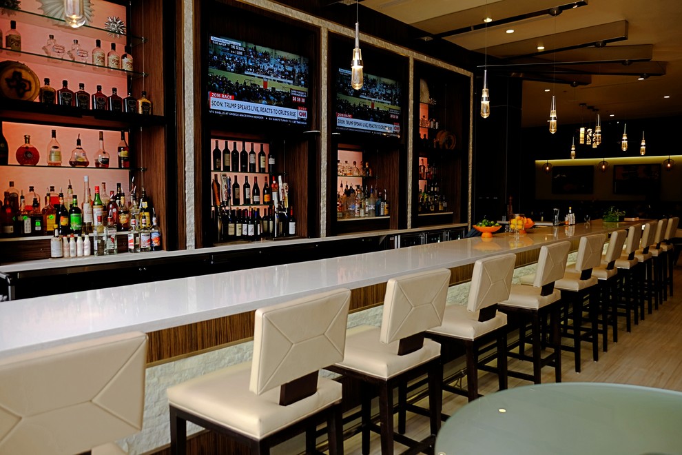 This is an example of a modern home bar in Houston.