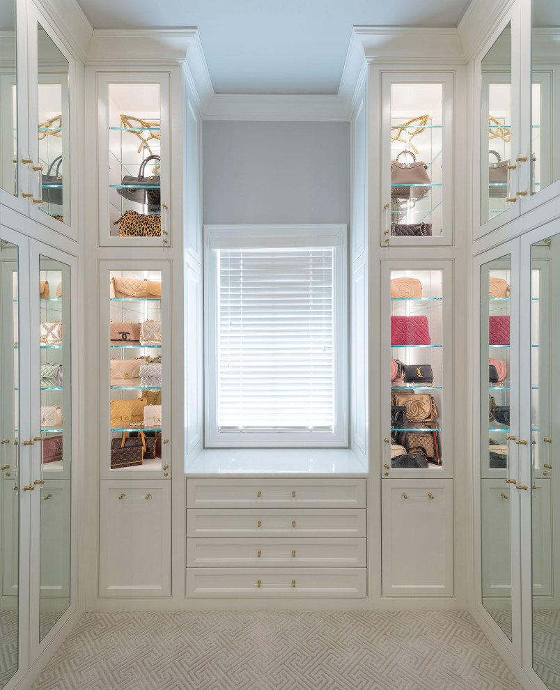This is an example of a large transitional gender-neutral walk-in wardrobe in Dallas with beaded inset cabinets, white cabinets, carpet and grey floor.
