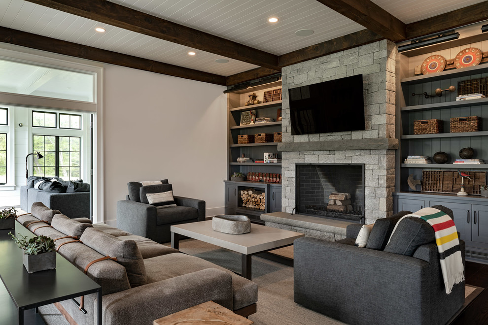 Inspiration for a large country enclosed living room in New York with white walls, a standard fireplace, a stone fireplace surround, a wall-mounted tv, dark hardwood floors and black floor.