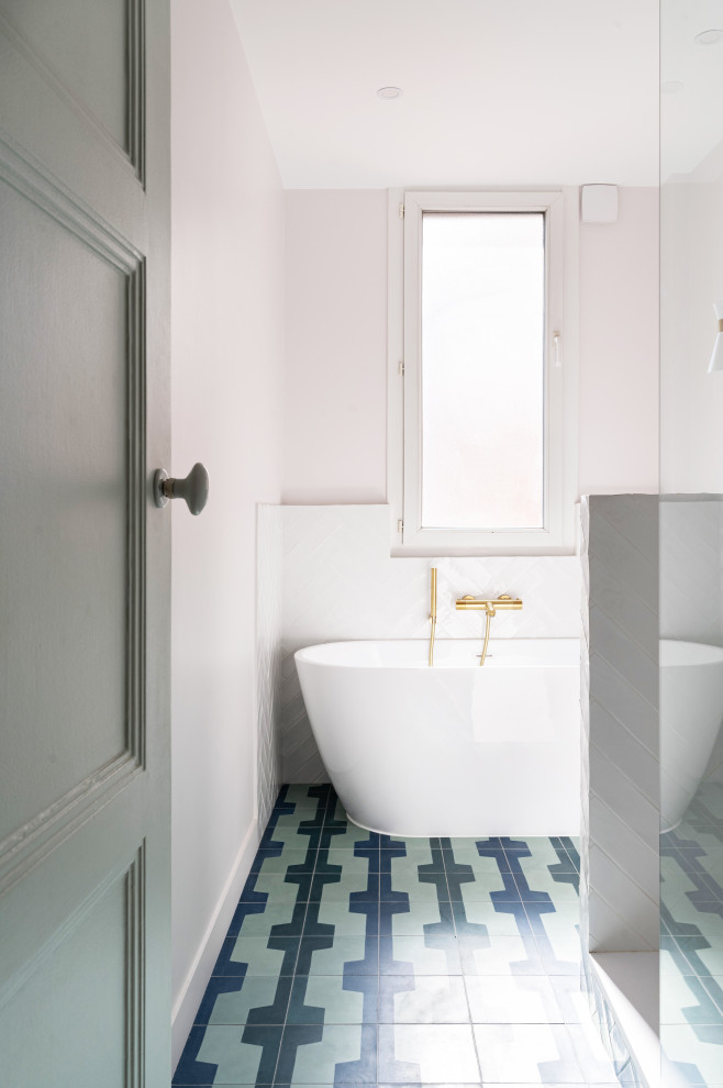 This is an example of a mid-sized contemporary master bathroom in Paris with beaded inset cabinets, brown cabinets, a drop-in tub, an open shower, a two-piece toilet, white tile, ceramic tile, white walls, cement tiles, a drop-in sink, wood benchtops, blue floor, an open shower, brown benchtops, a single vanity and a freestanding vanity.