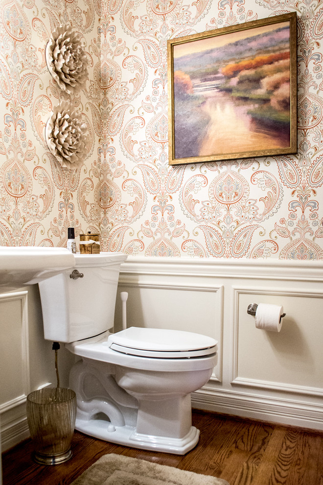 Design ideas for a small transitional powder room in Louisville with a one-piece toilet, multi-coloured walls, medium hardwood floors, a pedestal sink and brown floor.