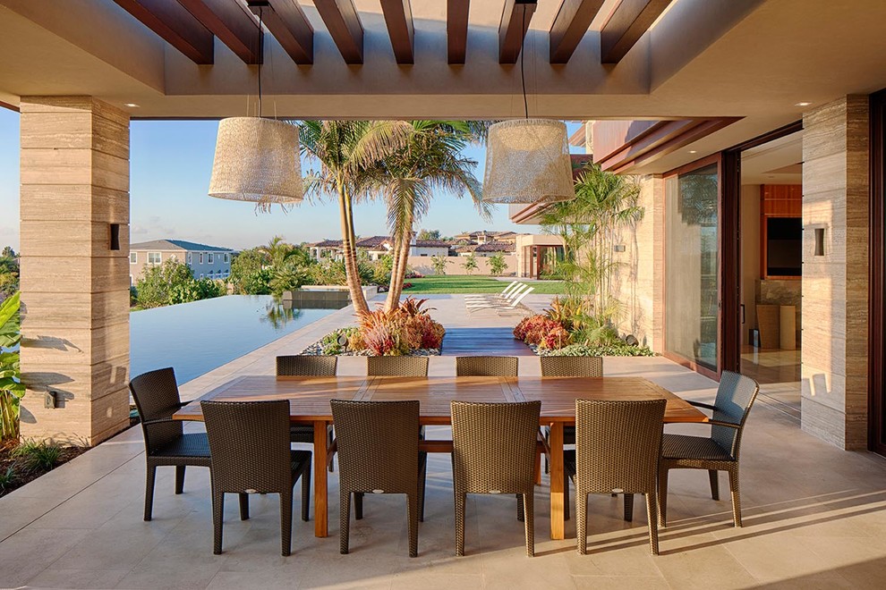 Photo of an expansive contemporary courtyard patio in San Diego with an outdoor kitchen, tile and a pergola.