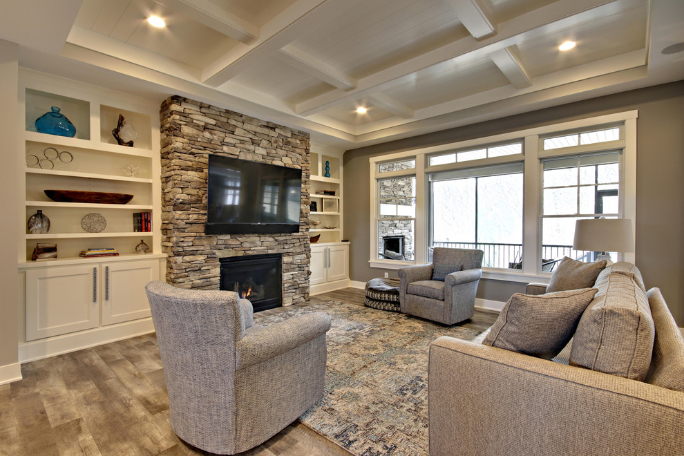 Large beach style formal open concept living room in Grand Rapids with beige walls, vinyl floors, a standard fireplace, a stone fireplace surround, a wall-mounted tv and multi-coloured floor.