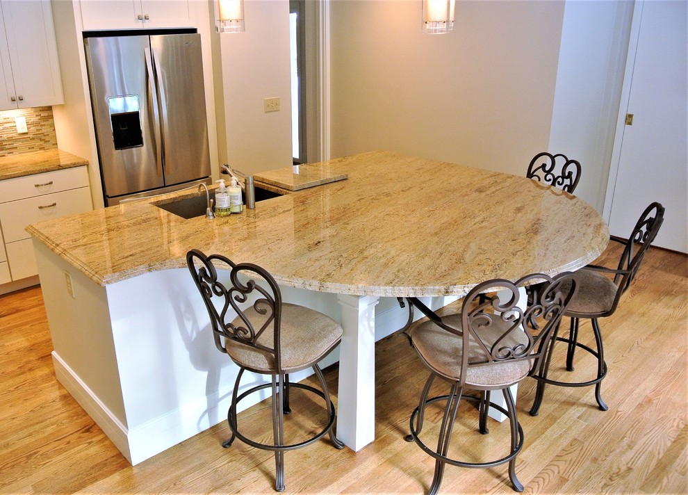Transitional light wood floor kitchen photo in Boston with an undermount sink, shaker cabinets, white cabinets, granite countertops, stainless steel appliances and an island